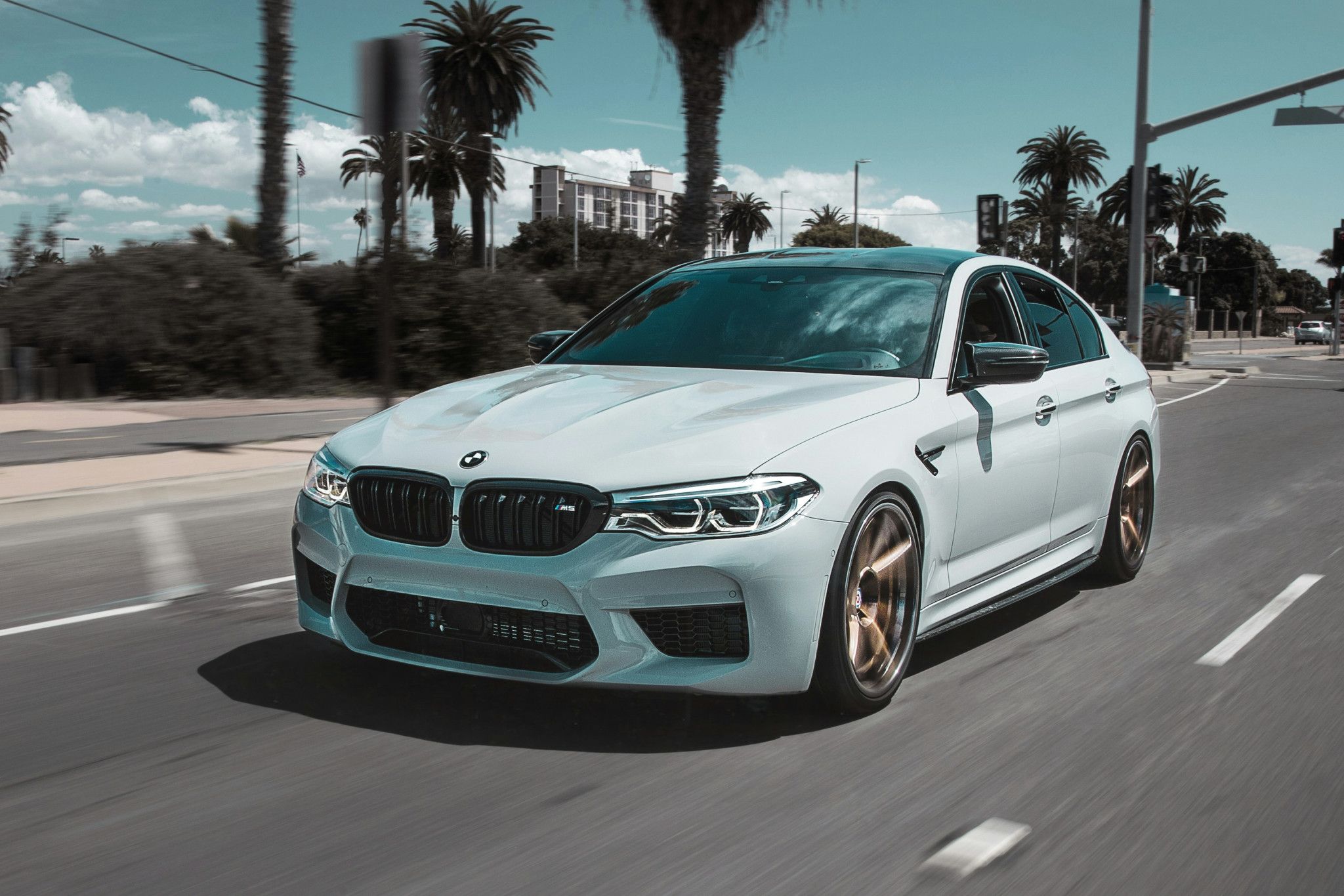 photo of blue BMW driving on road to Hoppers Service center for a european luxury car service